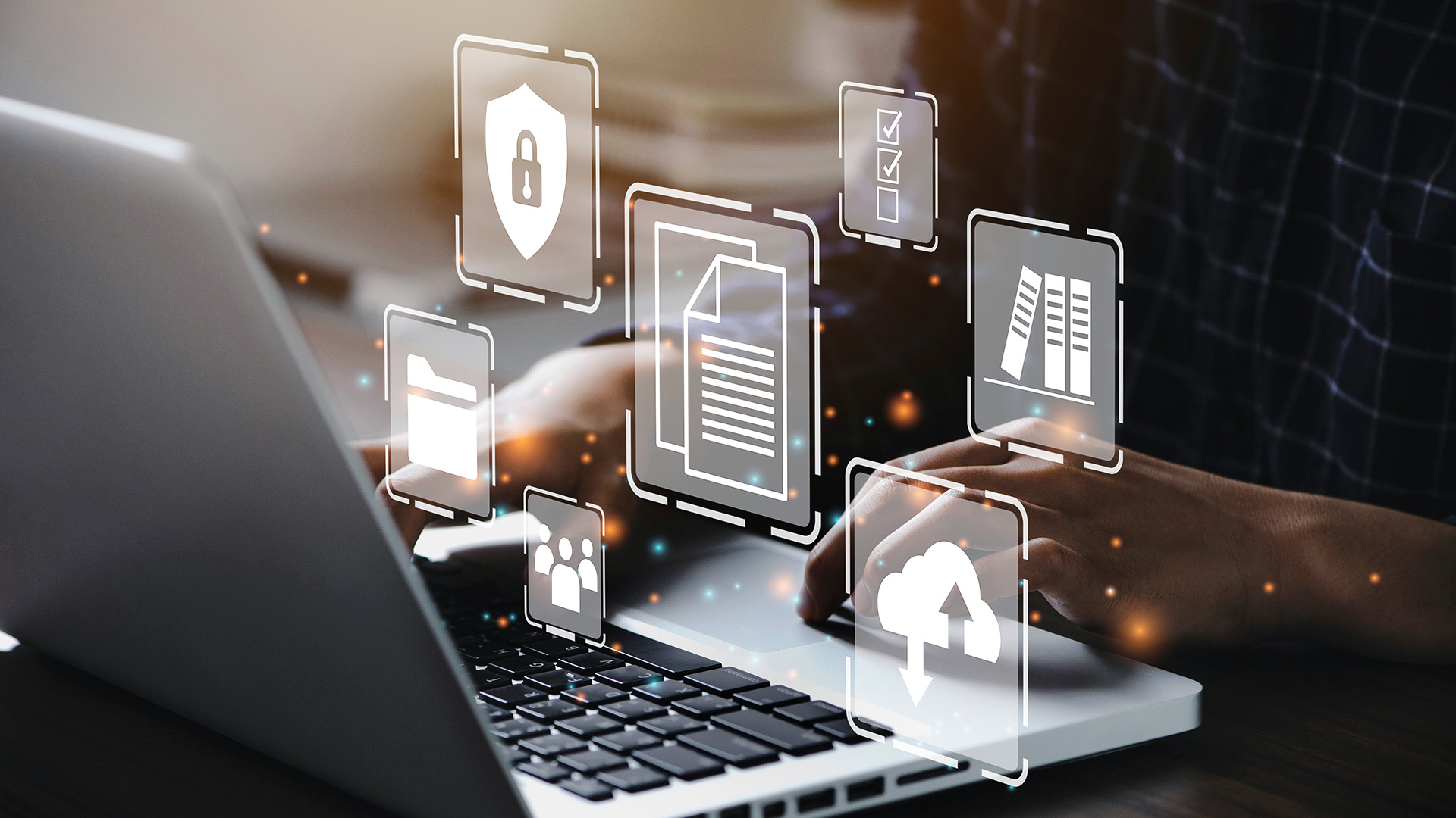 Hands typing on a laptop with digital document, cloud, and security icons overlaid, representing digital transformation and data management.