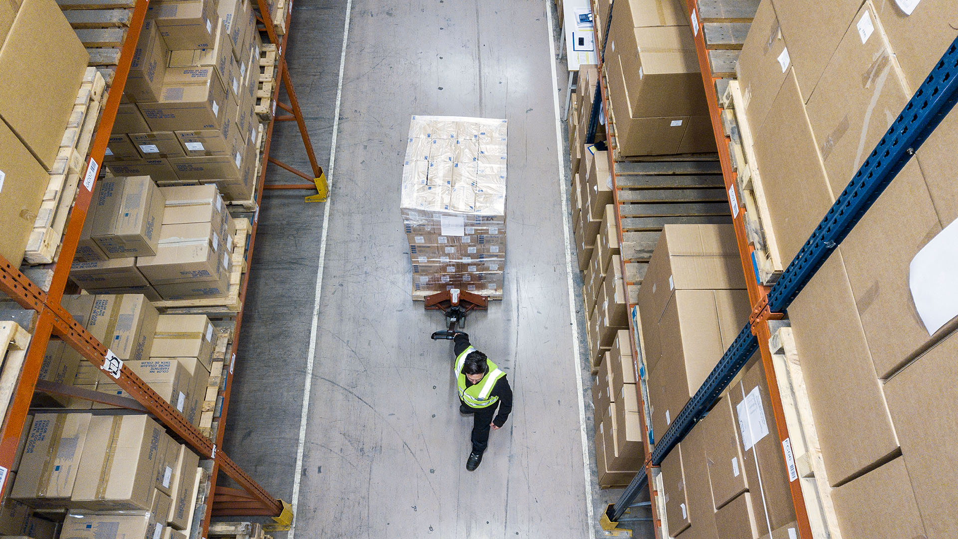 Overhead view of Brother warehouse logistics showing palletised cartons moved through distribution aisles for efficient order fulfilment.
