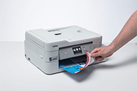 Hand removing double sided printed document from DCP-J1100DW