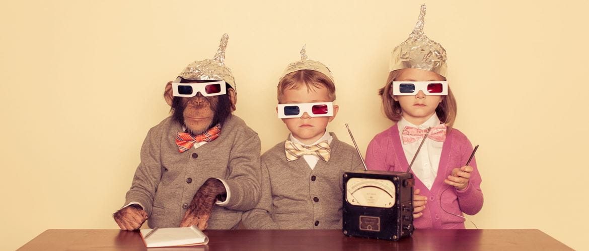 a monkey and two children wear foil hats to prevent alien communication