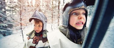 two boys dressed as knights go into battle