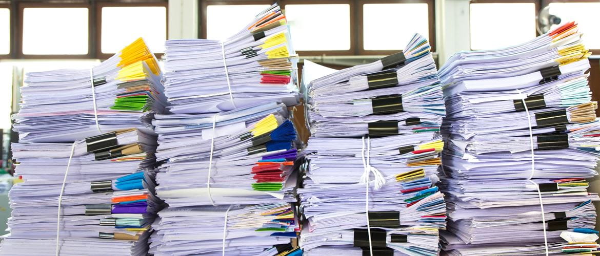 bundles of paper stacked high