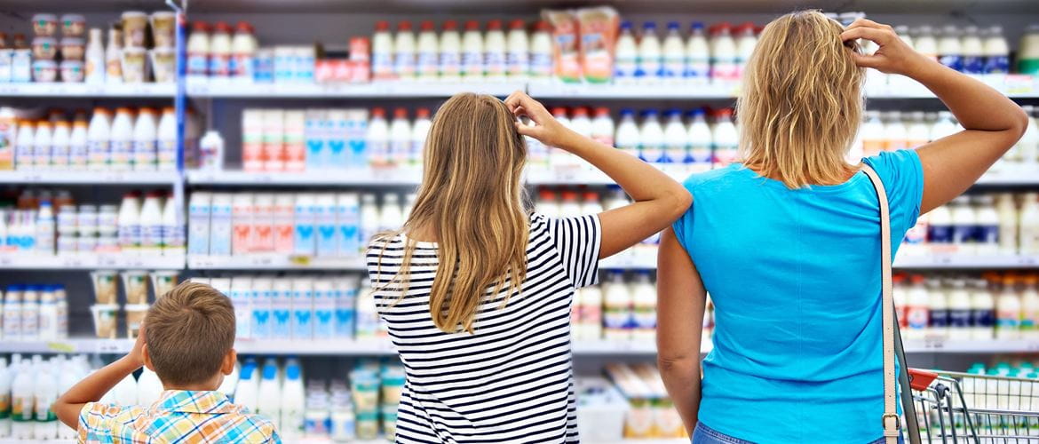 A family scratch their heads looking at a supermarket shelf to illustrate retail customer pain points