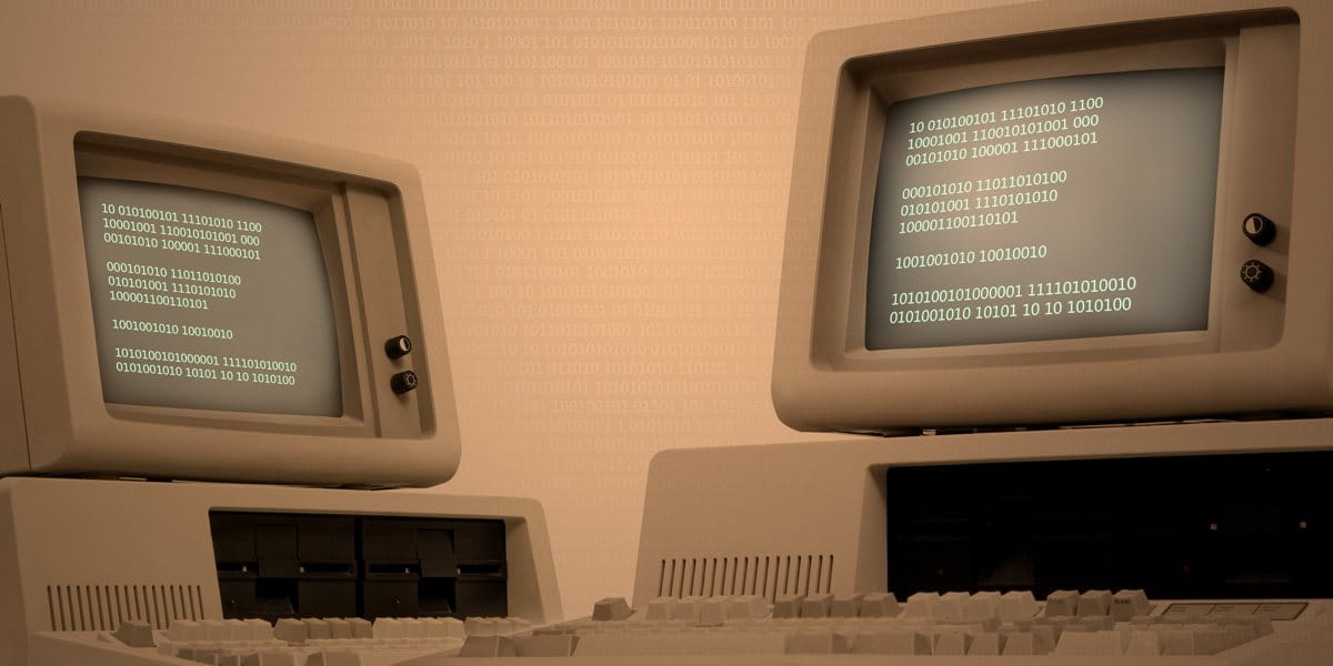two retro computers showing legacy technology systems within education