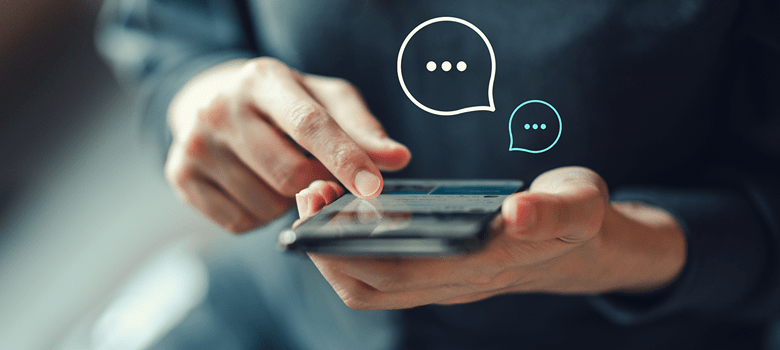 a woman holding a mobile phone using live chat messaging to get support