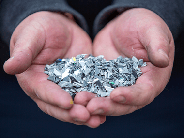 a hand holding plastic from Brother products ready to be recycled through sustainable pathways